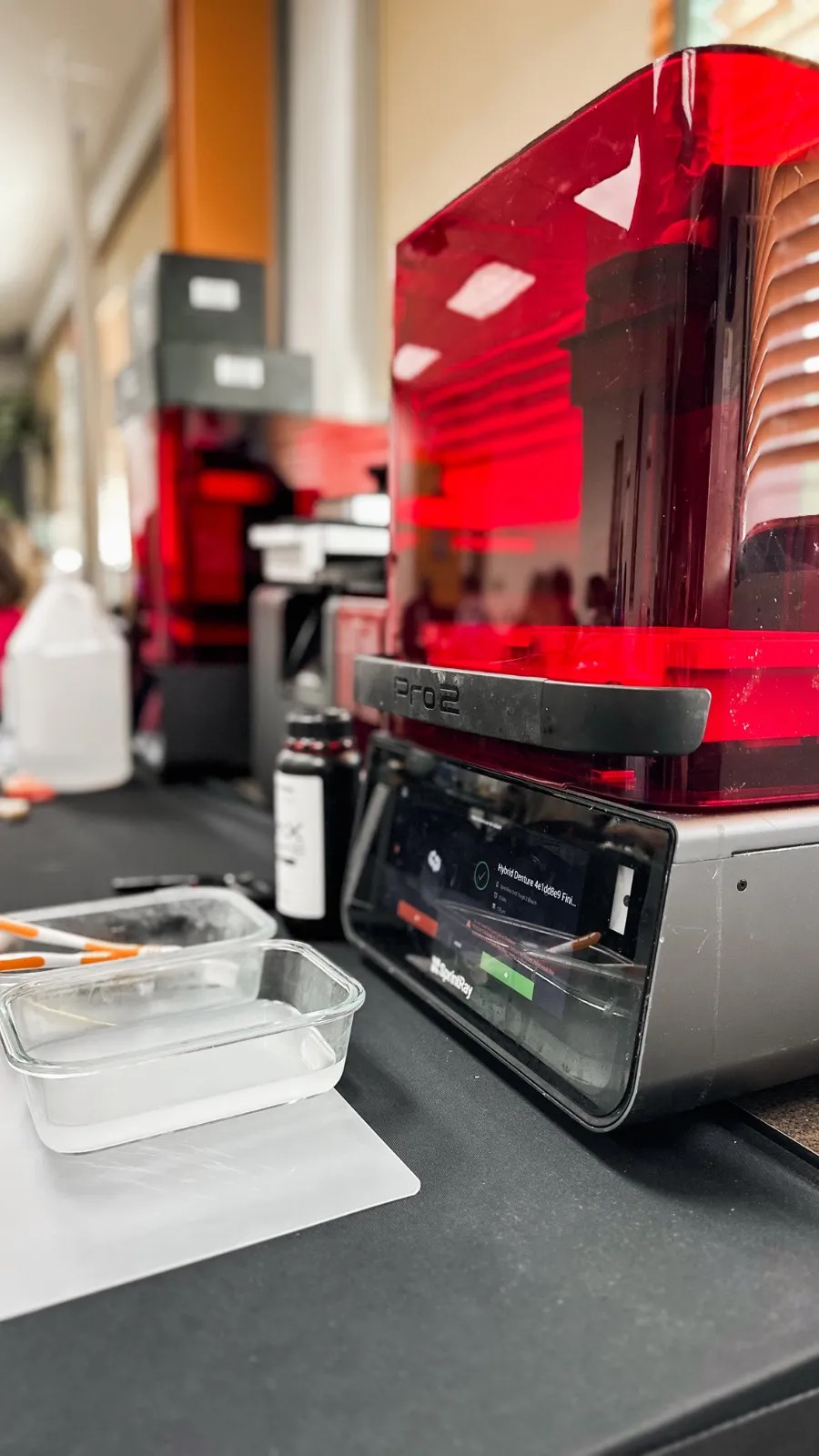 A SprintRay Pro 2 printer running a hybrid denture print during a live course