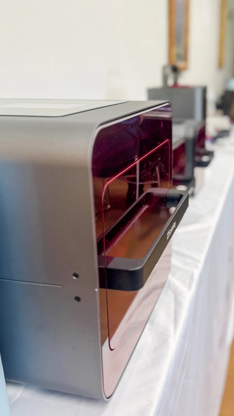 A row of SprintRay dental 3D printers set up for a live course at the institute